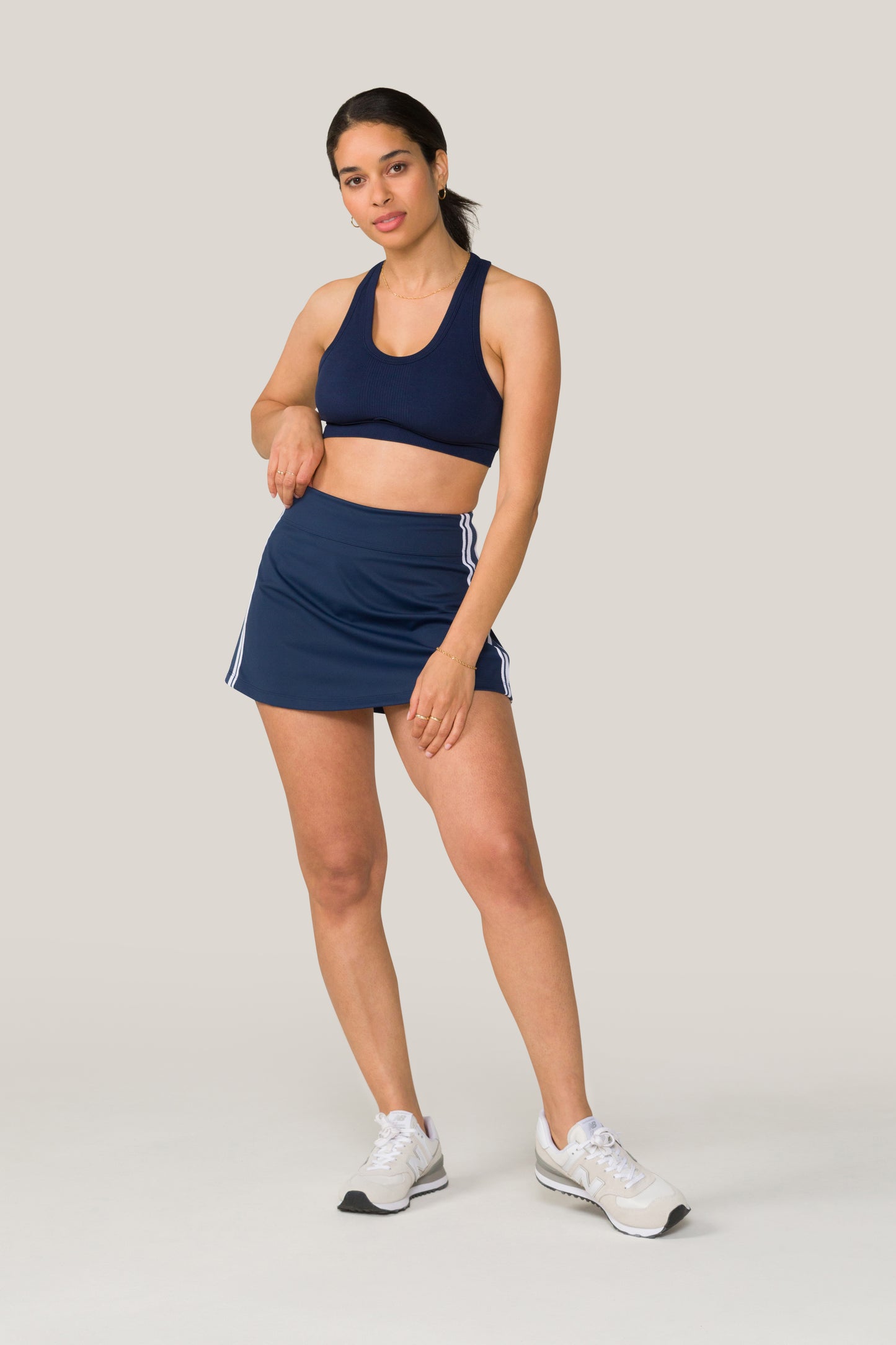 Alala women's tennis skort in navy with stripe detail