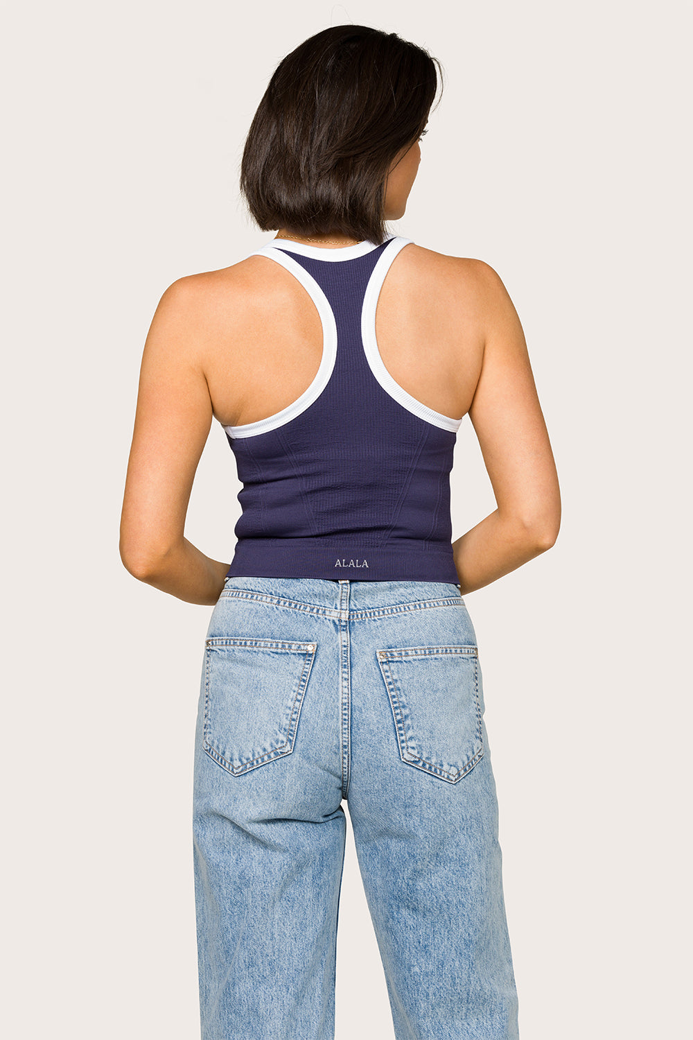 Alala women's seamless racerback tank top in navy with white details