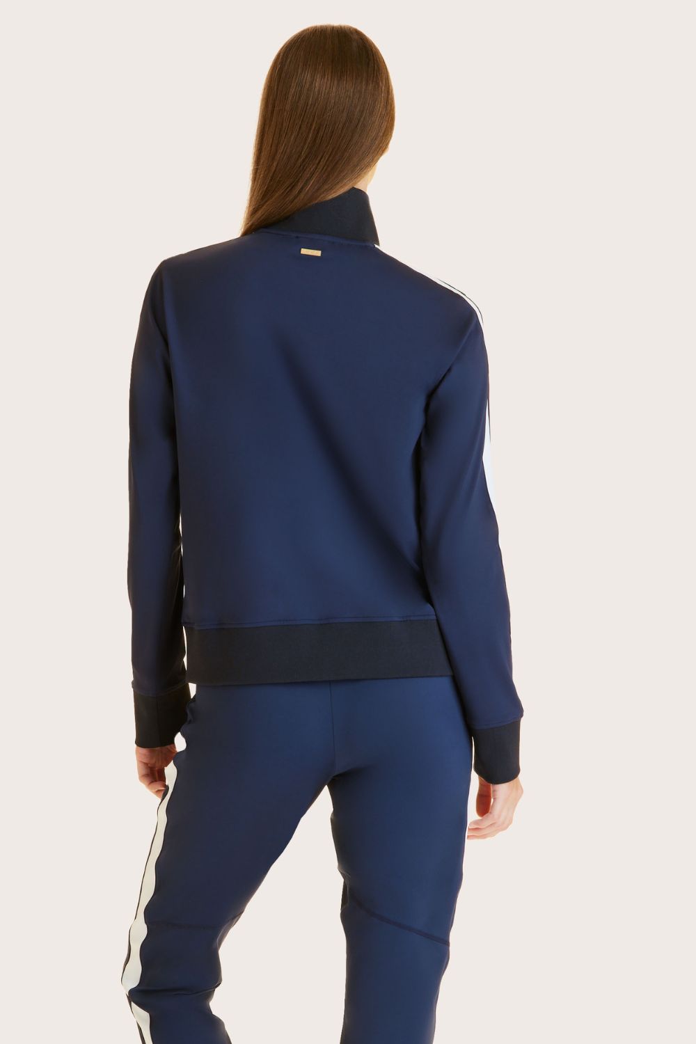 Alala women's track jacket in navy with white stripe