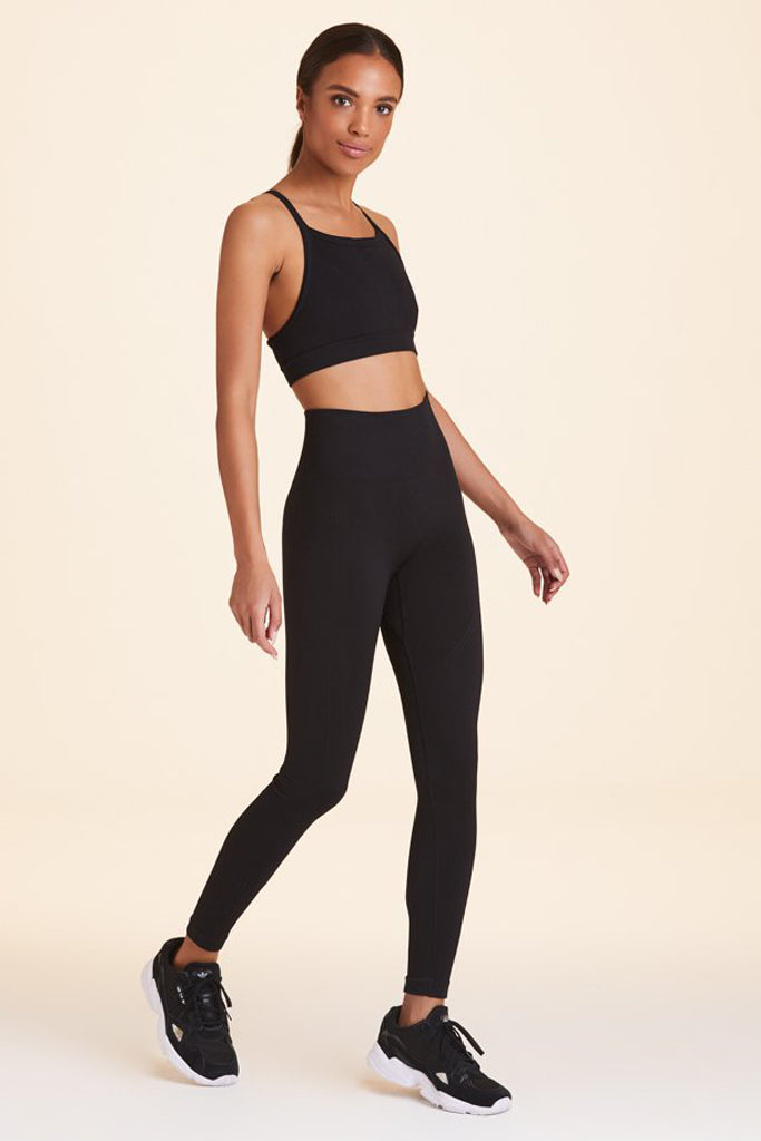 Front view of Alala Women's Luxury Athleisure flow seamless tight in black with rib detailing