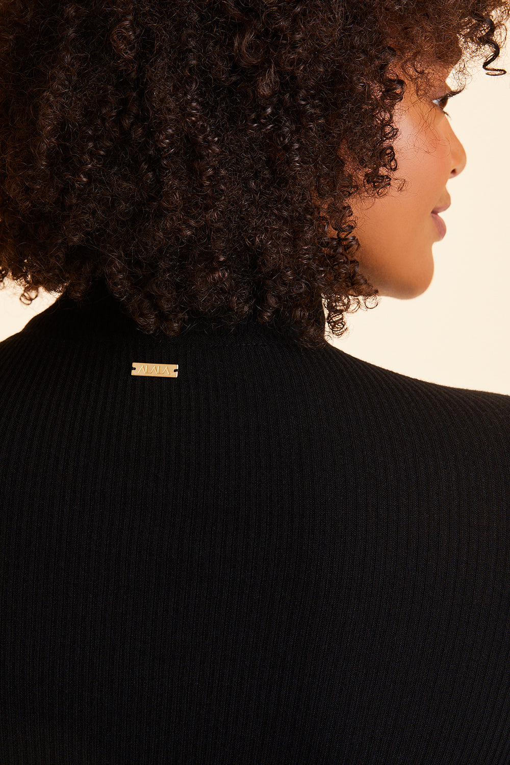 Back view close-up of Alala Women's Luxury Athleisure black ribbed zip up crop jacket in plus size