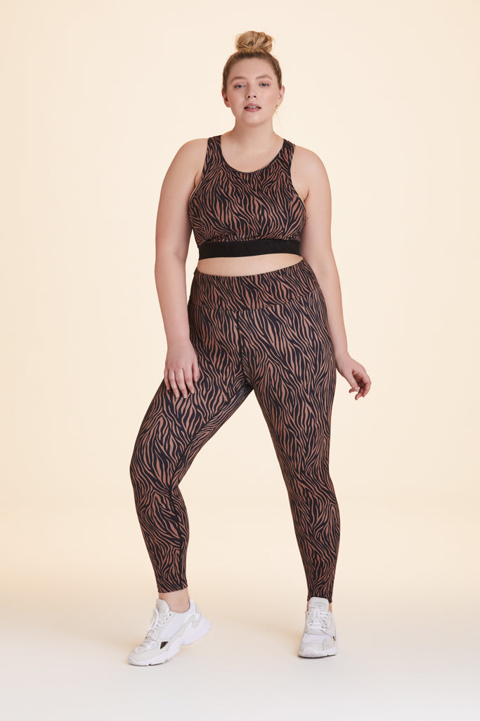 Front view of Alala Women's Luxury Athleisure zebra print tight in plus size