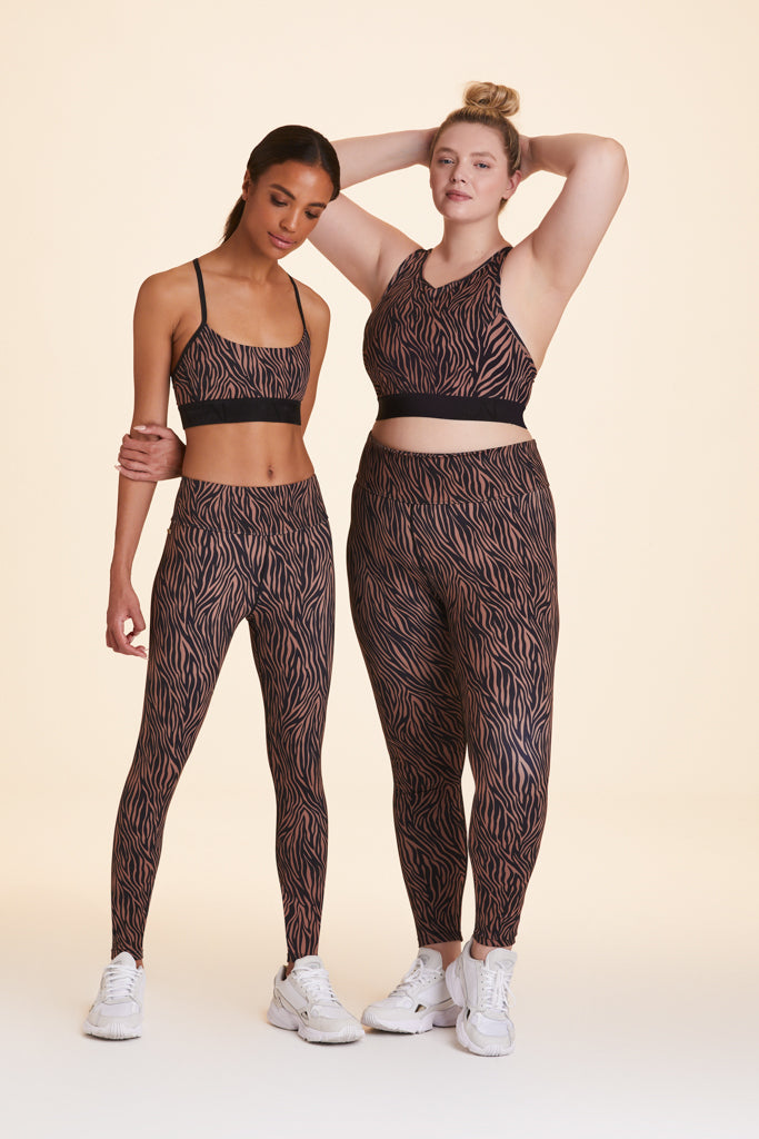 Front view of Alala Women's Luxury Athleisure zebra print tight