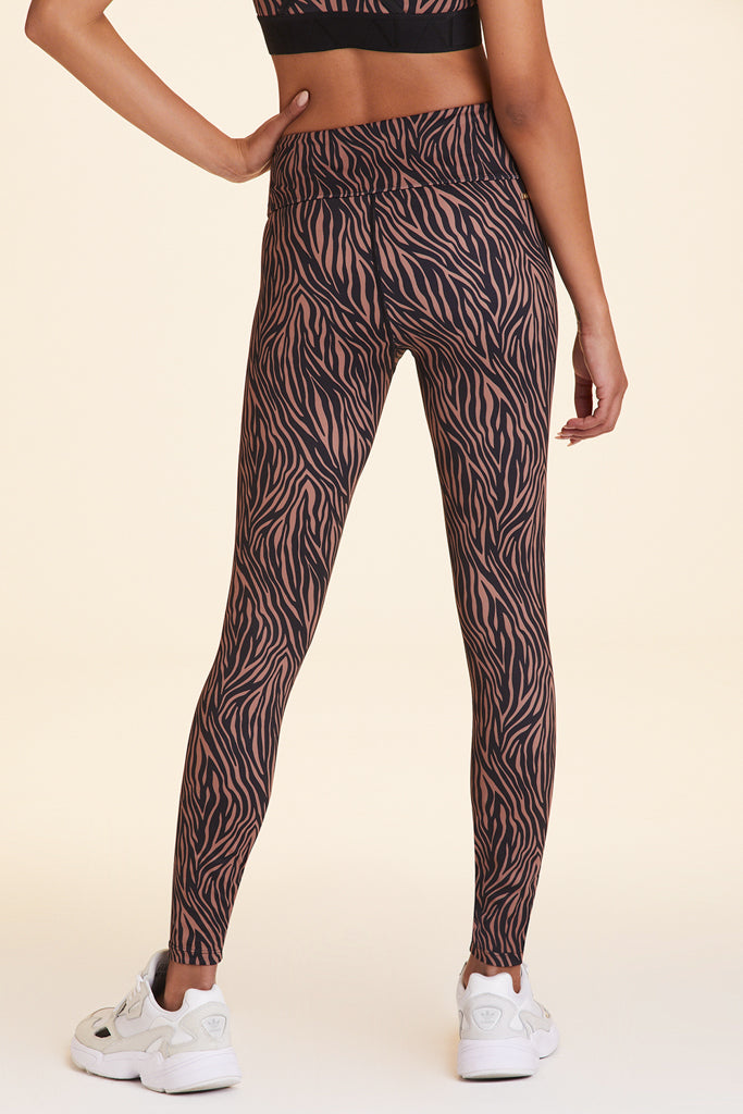 Back view of Alala Women's Luxury Athleisure zebra print tight