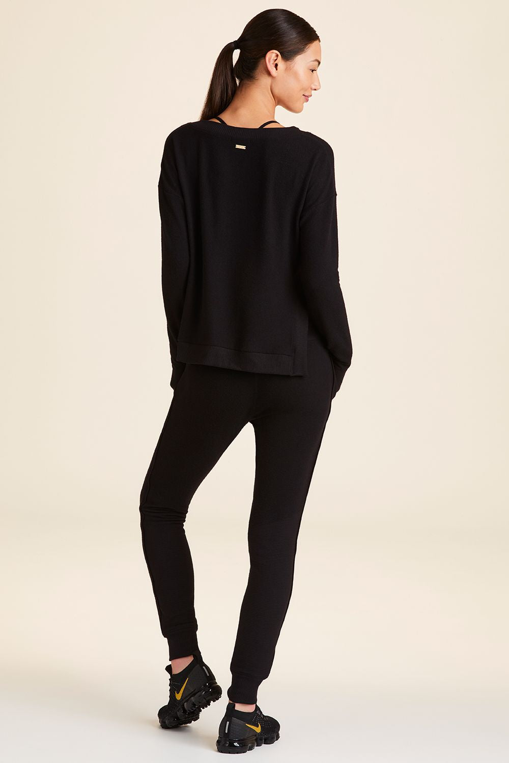 Full body back view of Alala Women's Luxury Athleisure wander sweatshirt in black