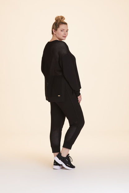 3/4 back view of Alala Women's Luxury Athleisure black crewneck sweatshirt in plus size
