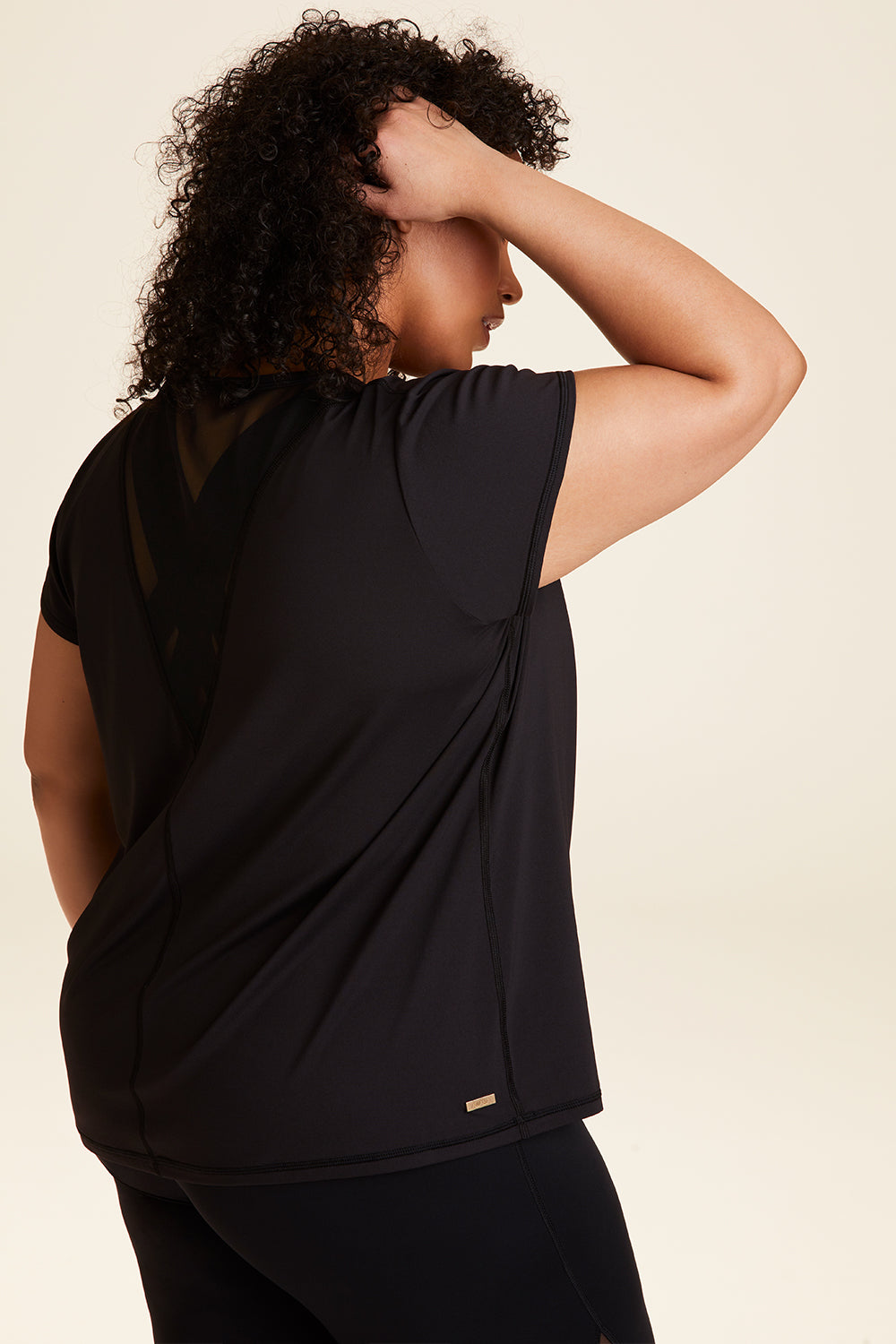 Side view of Alala Women's Luxury Athleisure blade tee in black