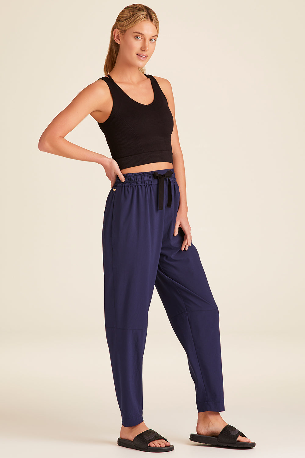 Full body front view of Alala Luxury Women's Athleisure commuter pant in navy