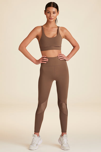 Full body frontal view of model with hands on hips dressed in mushroom Peak Tight legging