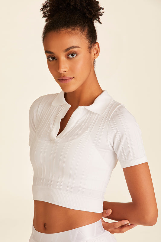 Closeup of model with arms behind wearing Seamless Polo from Alala in White