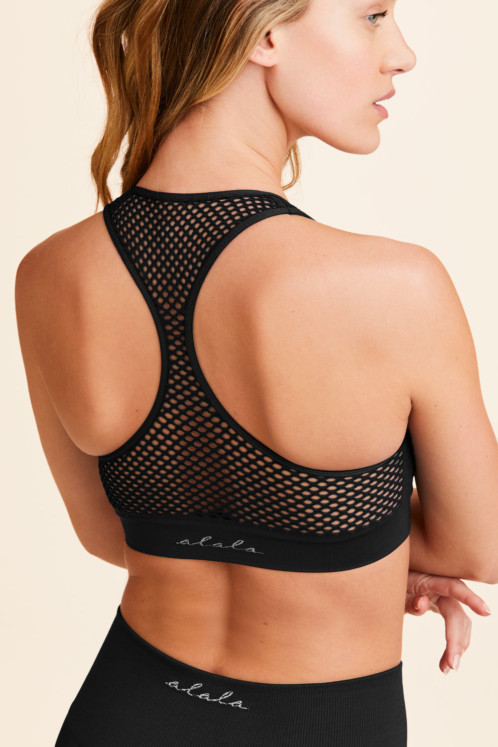Back view of Alala Women's Luxury Athleisure black seamless bra