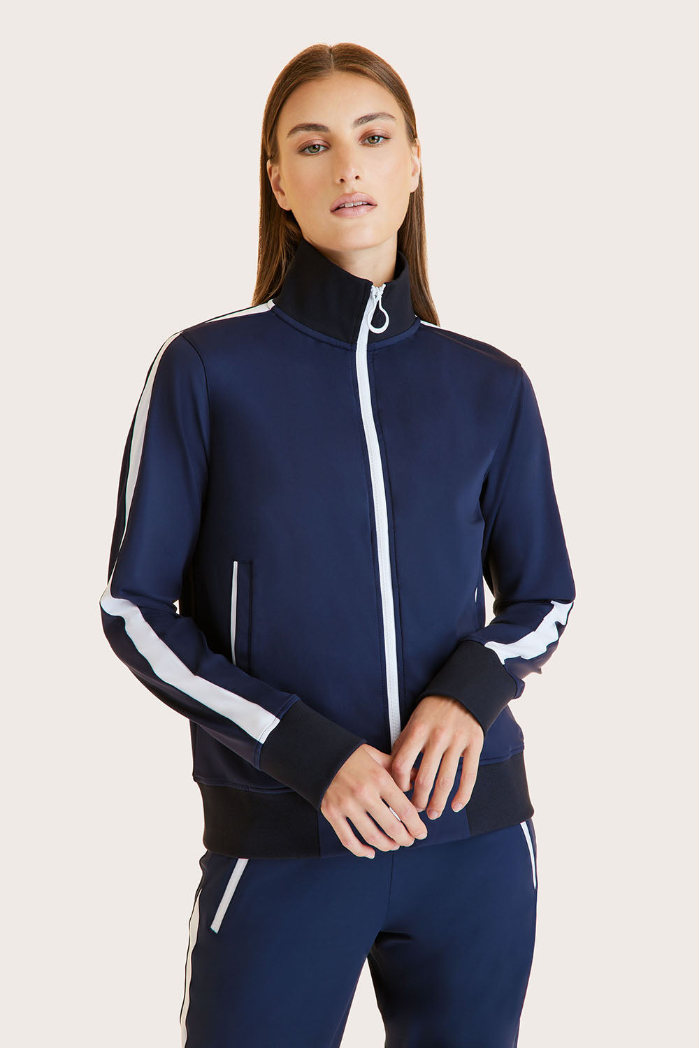 Alala women's track jacket in navy with white stripe