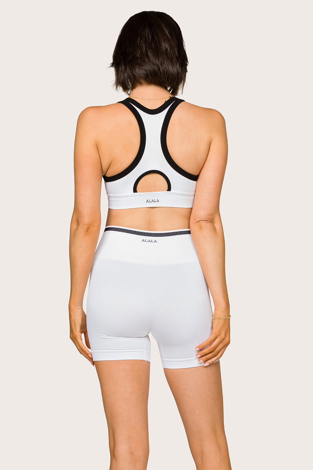 Alala women's seamless racerback bra with zipper in white with black details