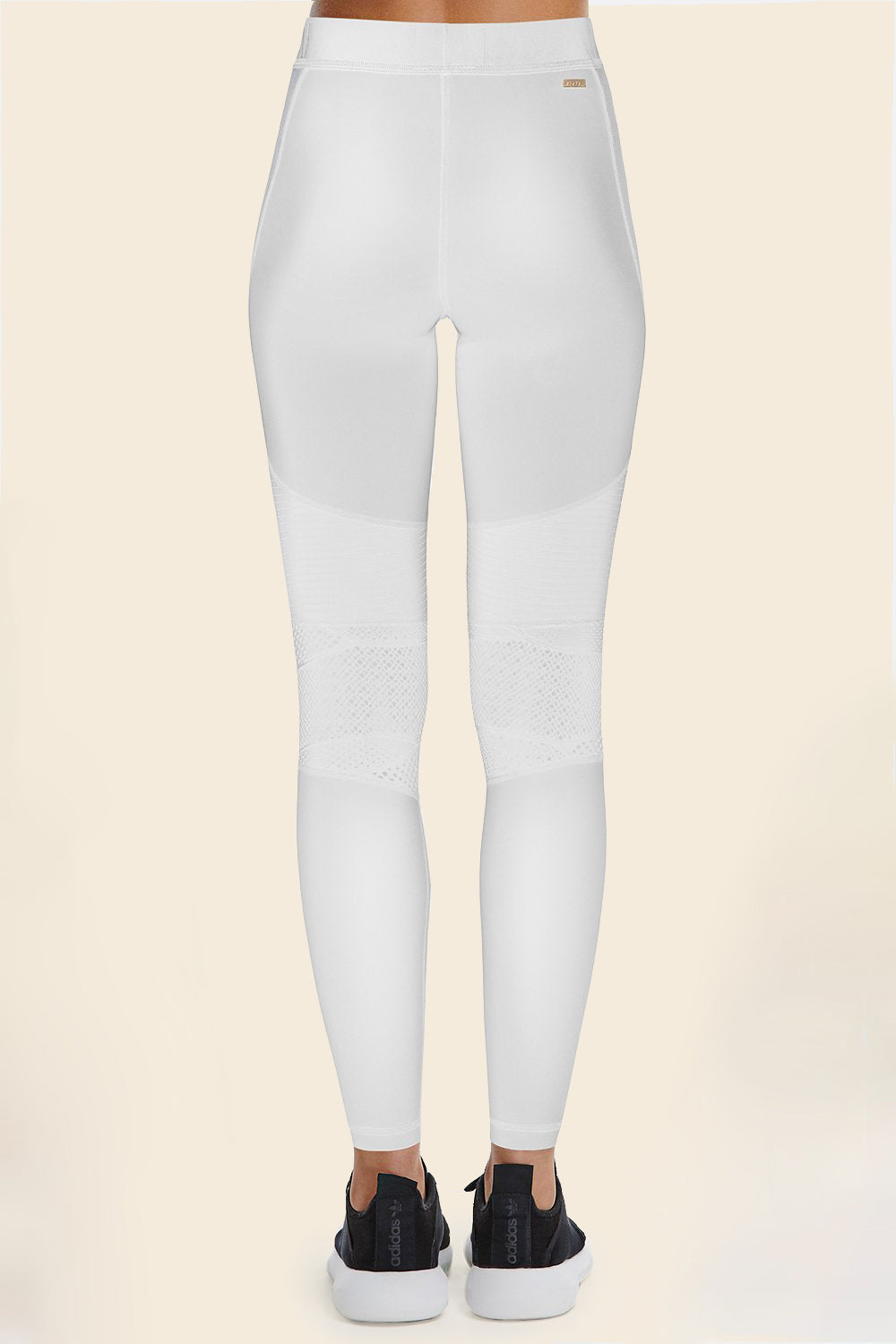 Back view of Alala Women's Luxury Athleisure harley tight in white with lace detailing