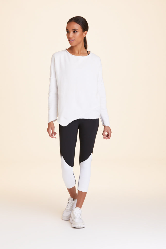 Front view of Alala Women's Luxury Athleisure white sweatshirt with distressed details on seams