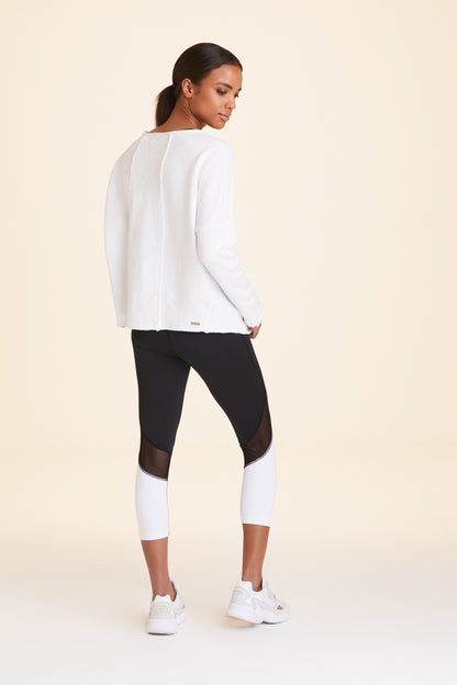 Back view of Alala Women's Luxury Athleisure white sweatshirt with distressed details on seams