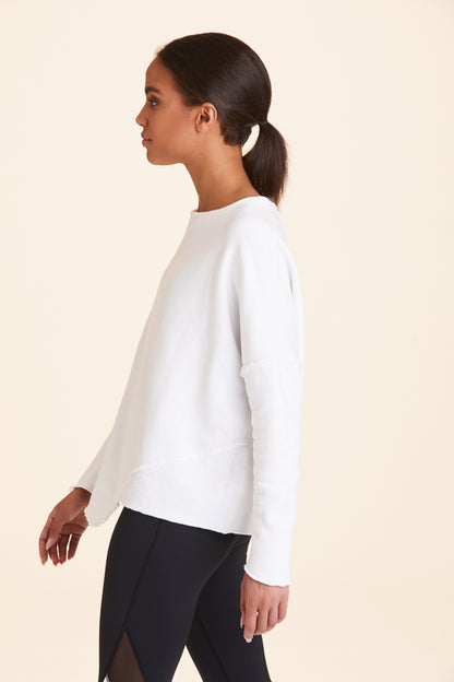 Side view of Alala Women's Luxury Athleisure white sweatshirt with distressed details on seams
