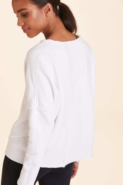 Back view of Alala Women's Luxury Athleisure white sweatshirt with distressed details on seams
