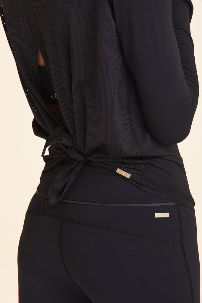 Back view close-up of Alala Women's Luxury Athleisure black long sleeve tie back