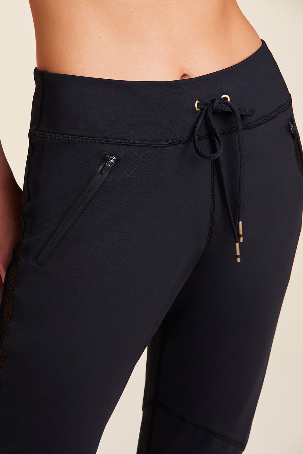 Front view close-up of Alala Women's Luxury Athleisure black sweatpant with sheer mesh side panel