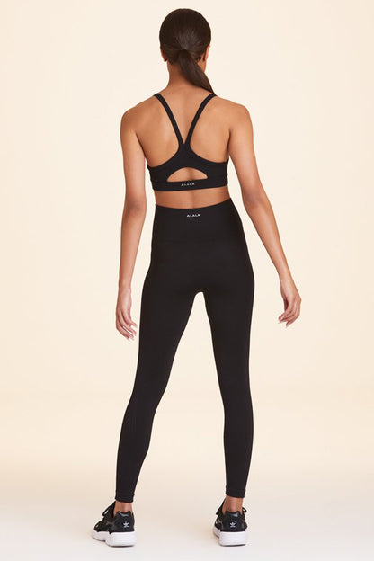 Back view of Alala Women's Luxury Athleisure flow seamless tight in black with rib detailing