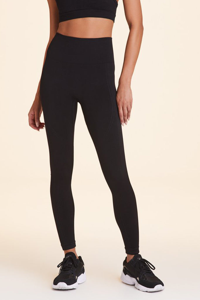 Front view of Alala Women's Luxury Athleisure flow seamless tight in black with rib detailing