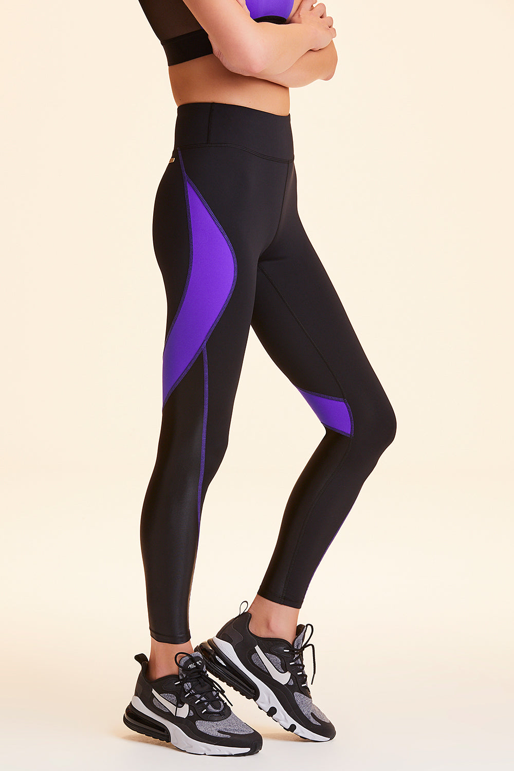 Side view of Alala Women's Luxury Athleisure black and purple color-blocked tight