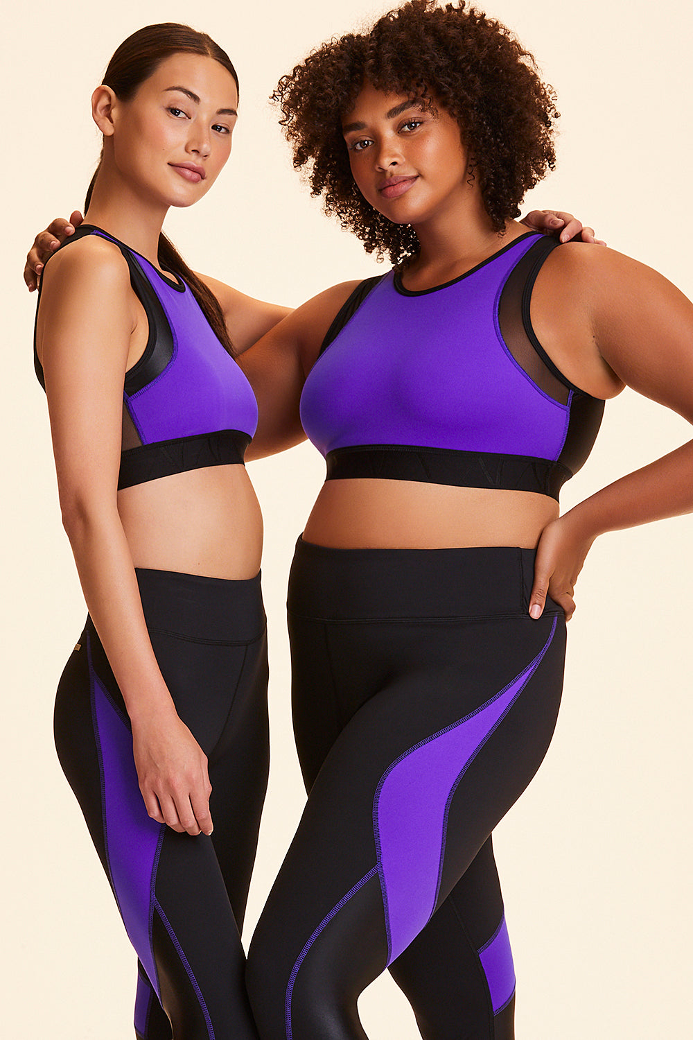 3/4 view of Alala Women's Luxury Athleisure black and purple color-blocked sports bra