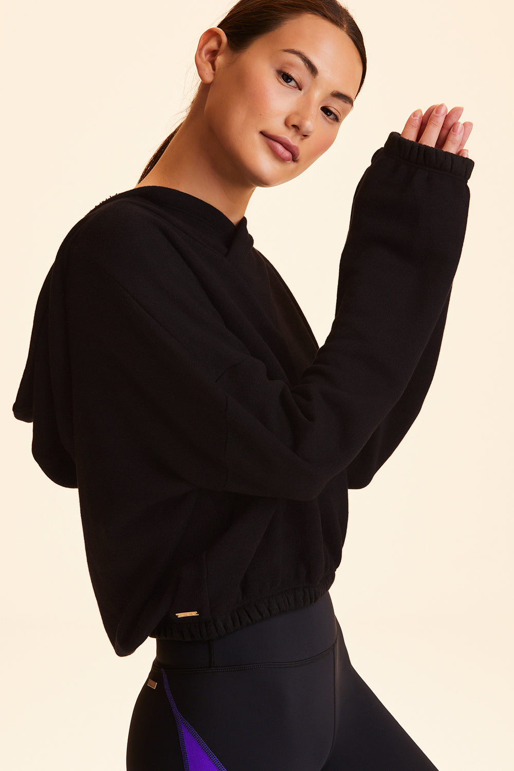 Side view of Alala Women's Luxury Athleisure black cropped sweatshirt