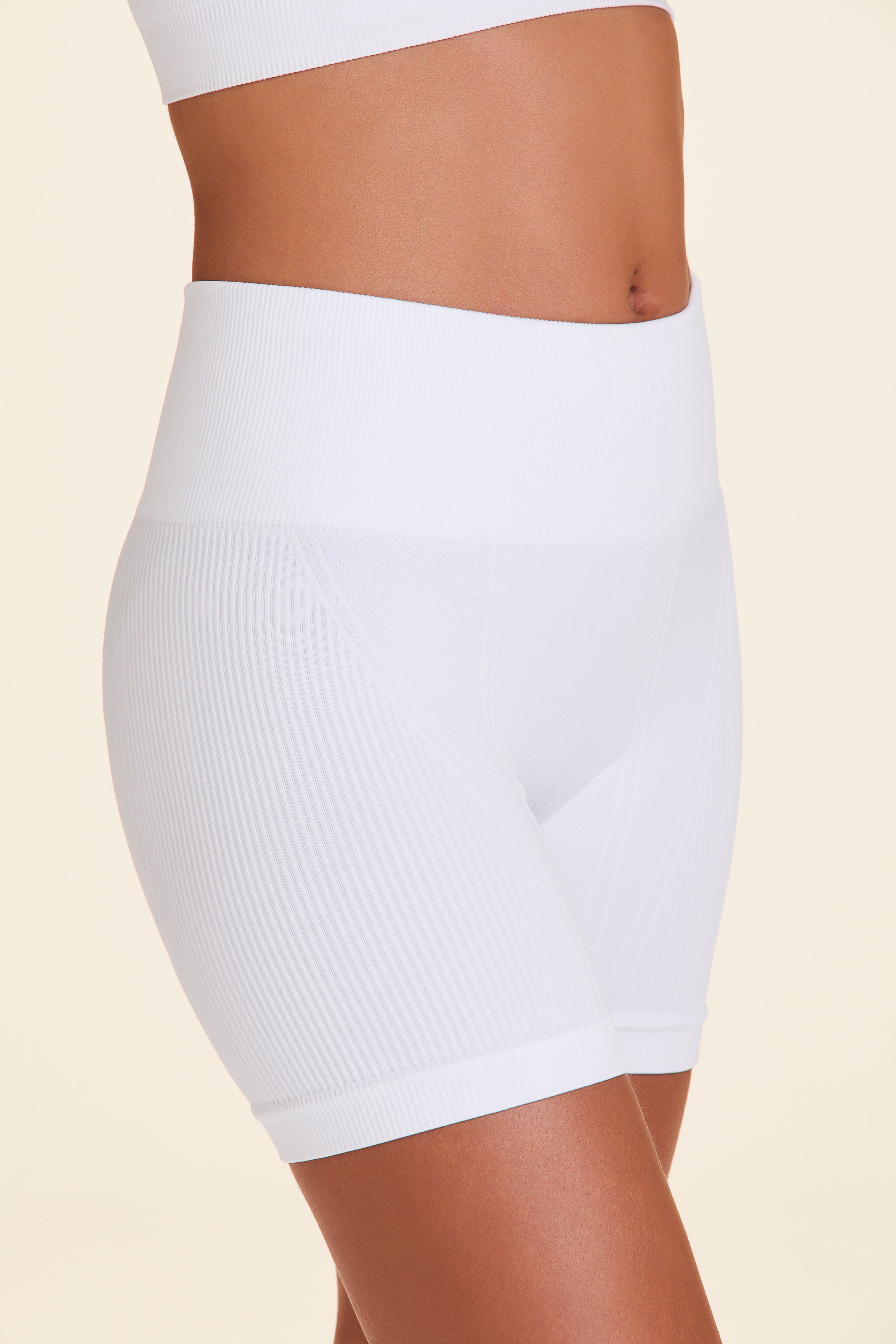Zoomed in front view of Alala Luxury Women's Athleisure barre seamless short in white