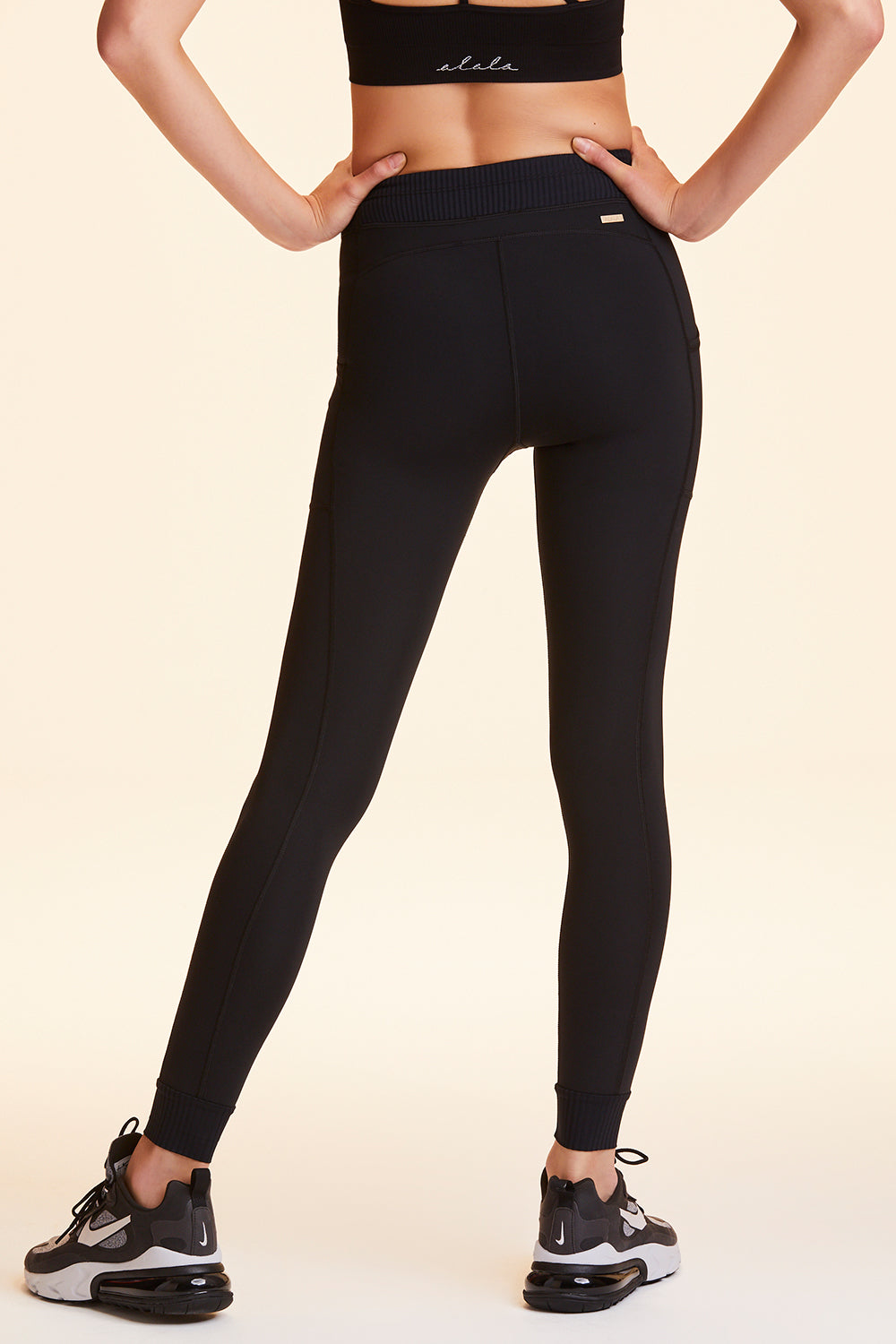 Back view of Alala Women's Luxury Athleisure black jogger-style tight