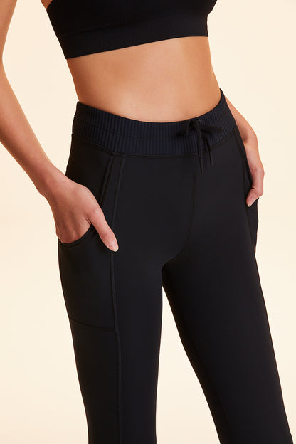 Front view of Alala Women's Luxury Athleisure black jogger-style tight