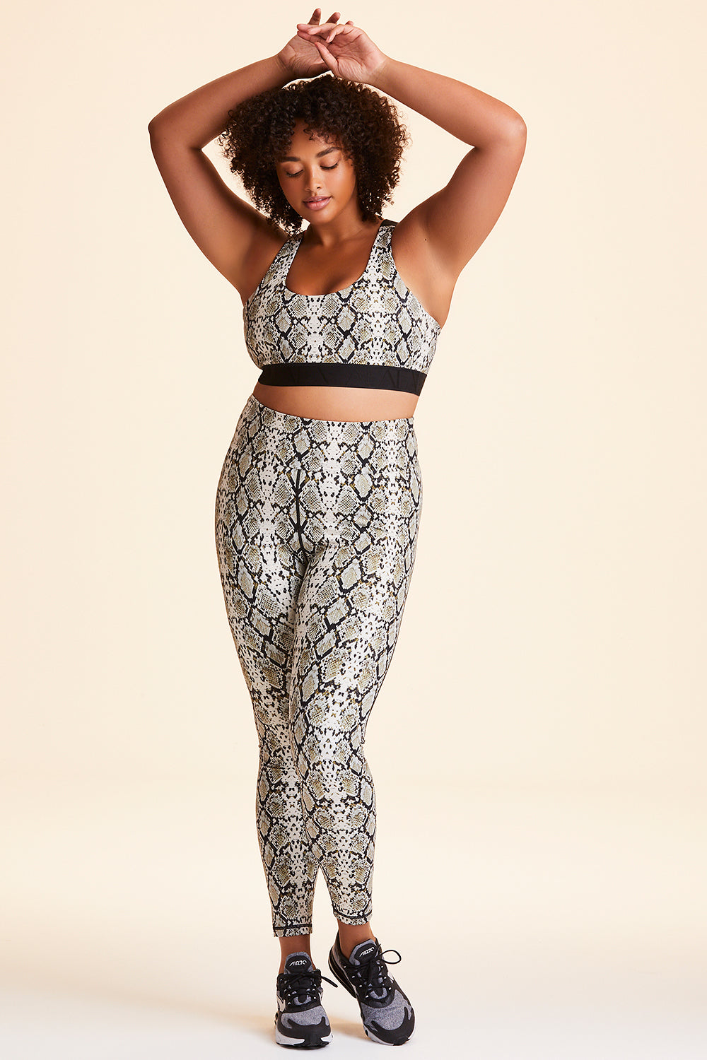 Front view of Alala Women's Luxury Athleisure snakeprint tight with mesh paneling on back of knees in plus size