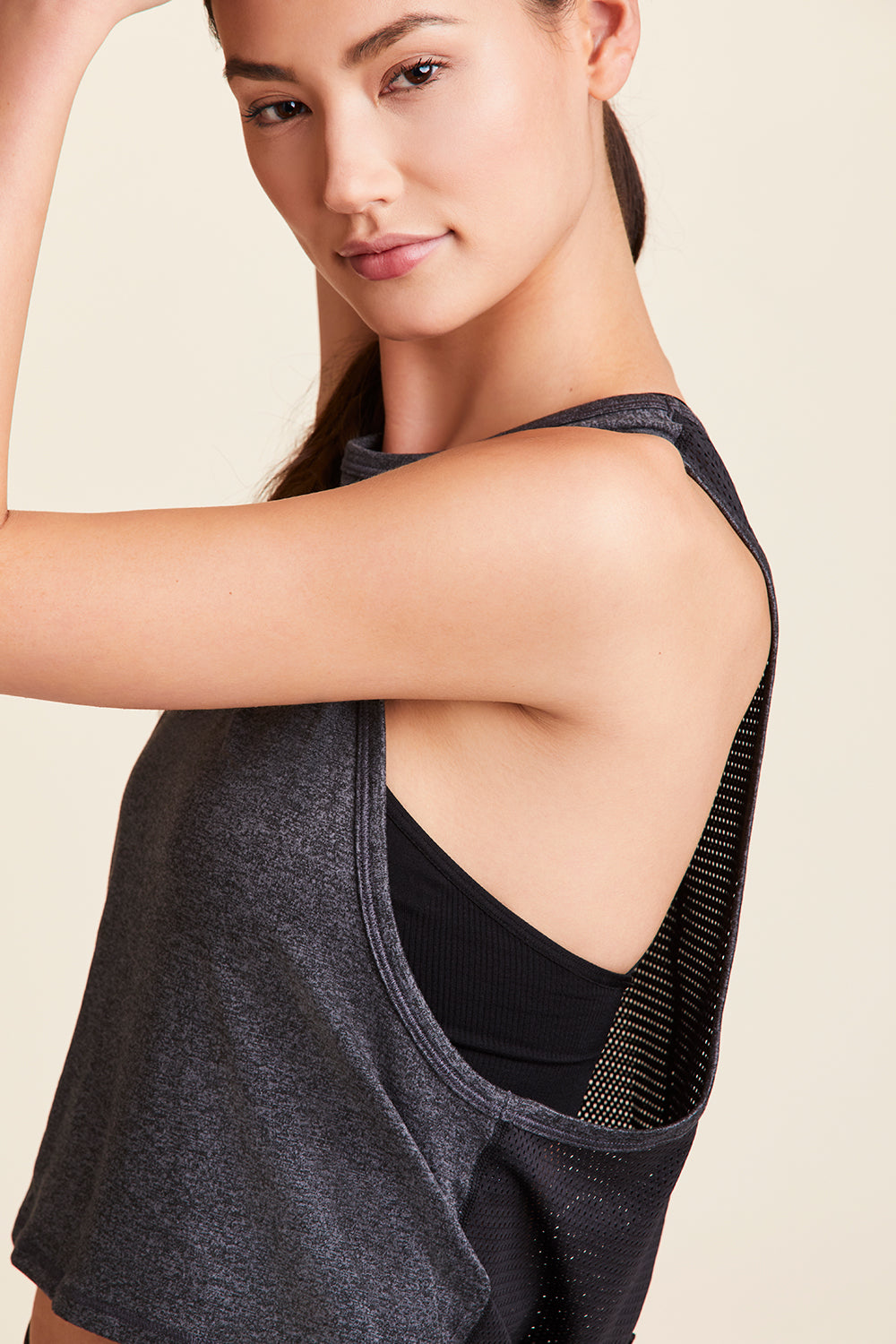 Side view of Alala Women's Luxury Athleisure charcoal mesh tie back tank