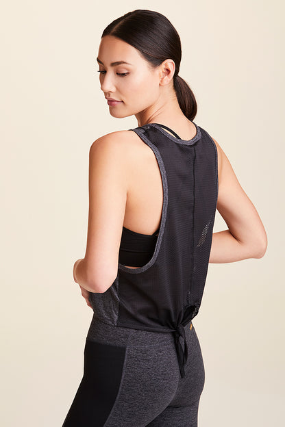 3/4 back view of Alala Women's Luxury Athleisure charcoal mesh tie back tank