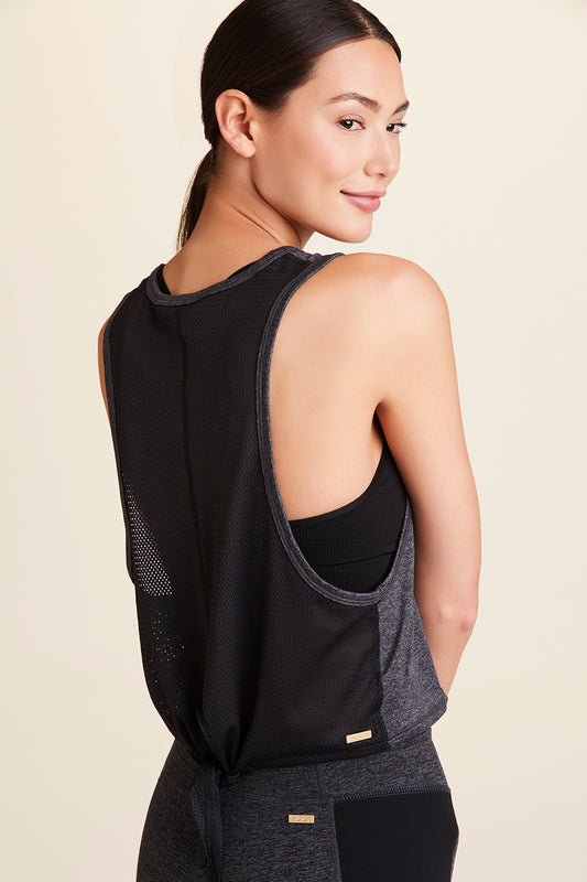 3/4 back view of Alala Women's Luxury Athleisure charcoal mesh tie back tank