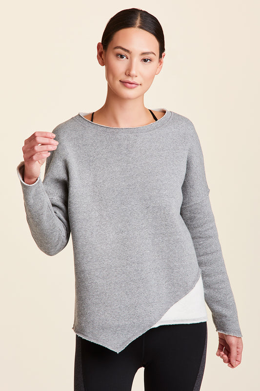 Front view of Alala Women's Luxury Athleisure grey sweatshirt with distressed details on seams