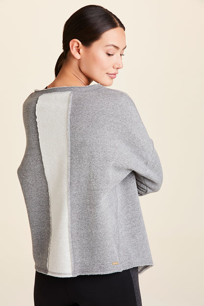 Back view of Alala Women's Luxury Athleisure grey sweatshirt with distressed details on seams