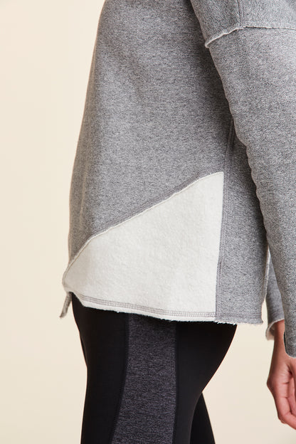 Side view close-up of Alala Women's Luxury Athleisure grey sweatshirt with distressed details on seams