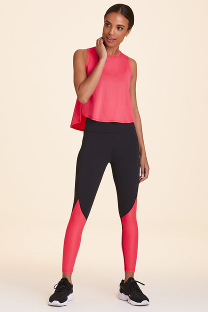 Front view of Alala Women's Luxury Athleisure black and watermelon color-blocked tight