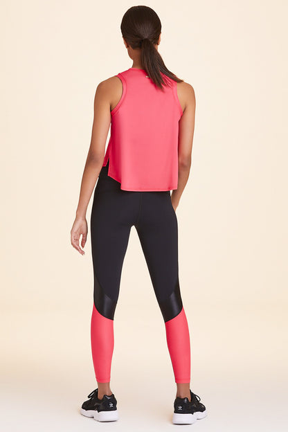 Back view of Alala Women's Luxury Athleisure black and watermelon color-blocked tight