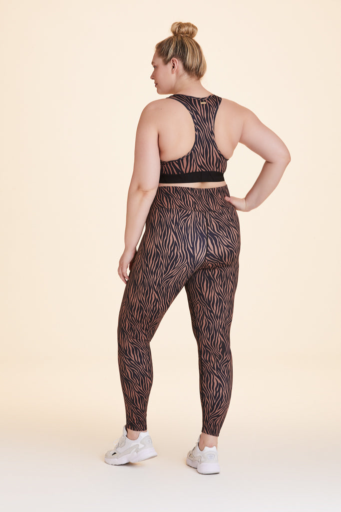 Back view of Alala Women's Luxury Athleisure brown and black tiger-striped racerback bra in plus size