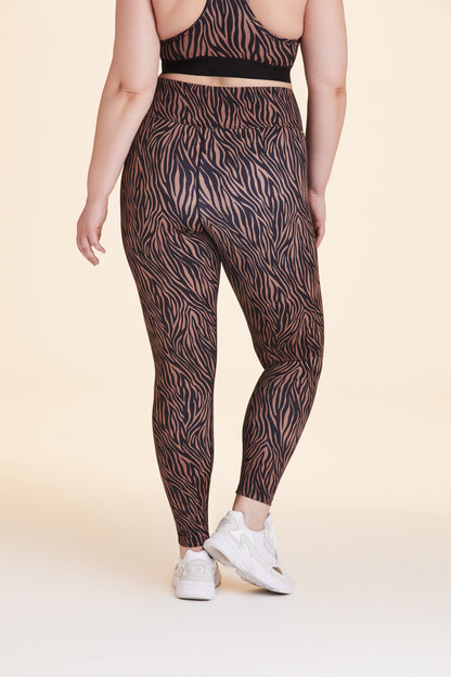 Back view of Alala Women's Luxury Athleisure zebra print tight in plus size