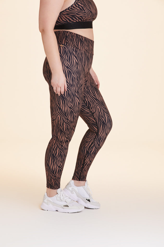 Side view of Alala Women's Luxury Athleisure zebra print tight in plus size