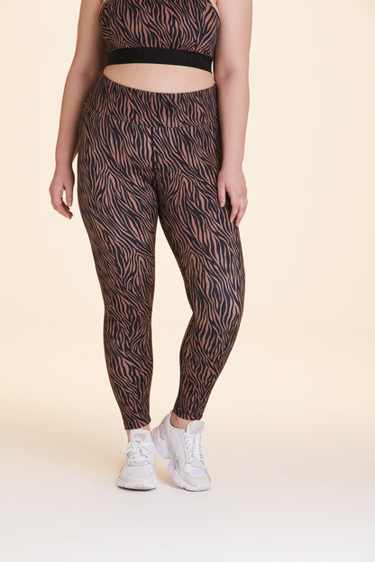 Front view of Alala Women's Luxury Athleisure zebra print tight in plus size