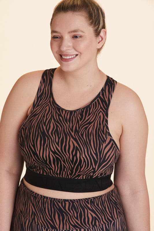 Front view of Alala Women's Luxury Athleisure brown and black tiger-striped  racerback bra in plus size