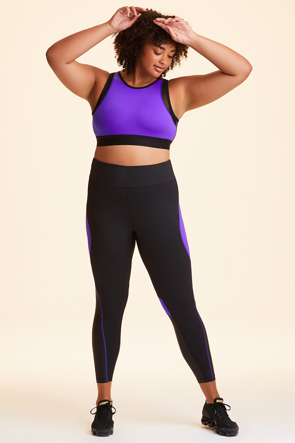 Front view of Alala Women's Luxury Athleisure black and purple color-blocked tight in plus size
