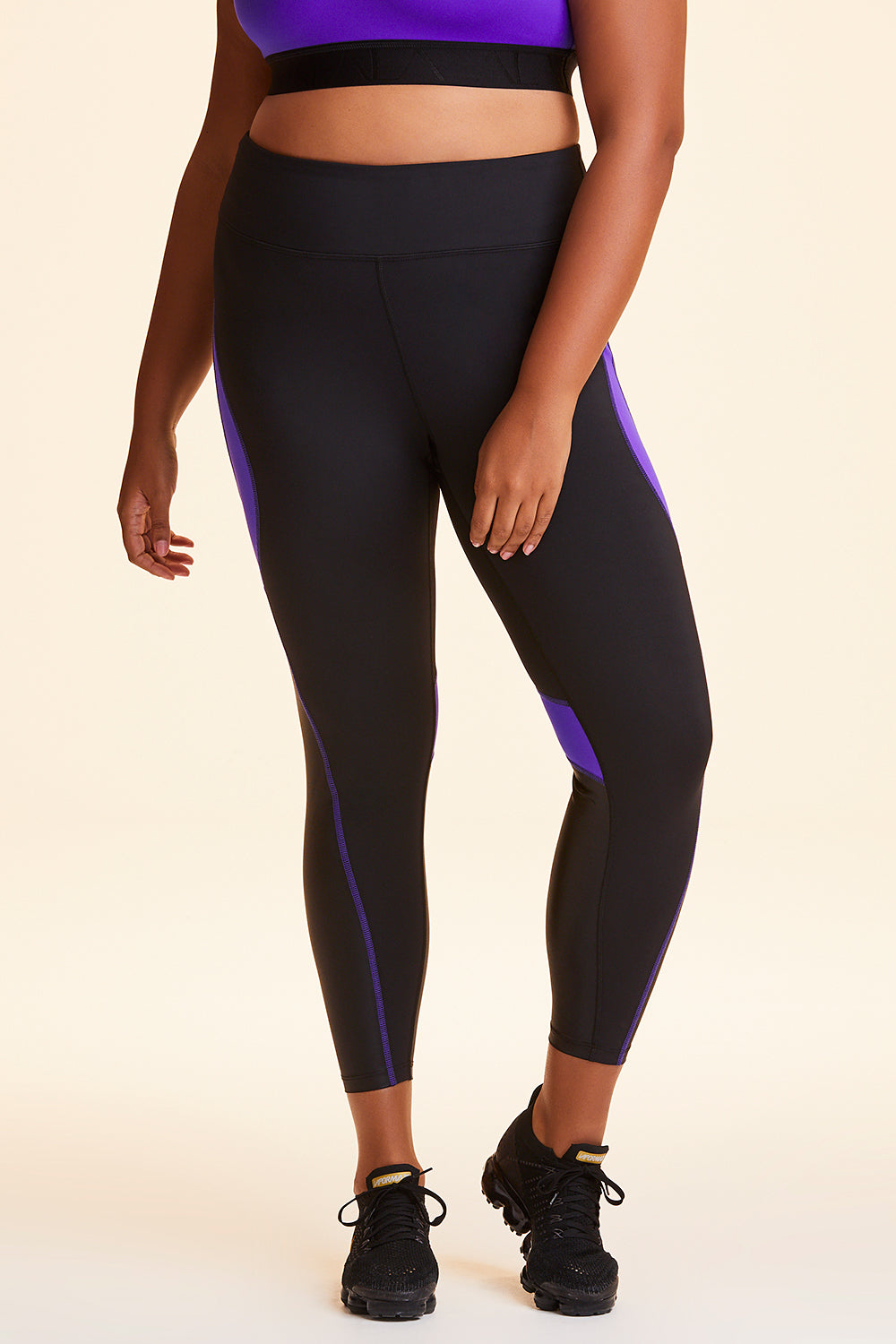 Front view of Alala Women's Luxury Athleisure black and purple color-blocked tight in plus size