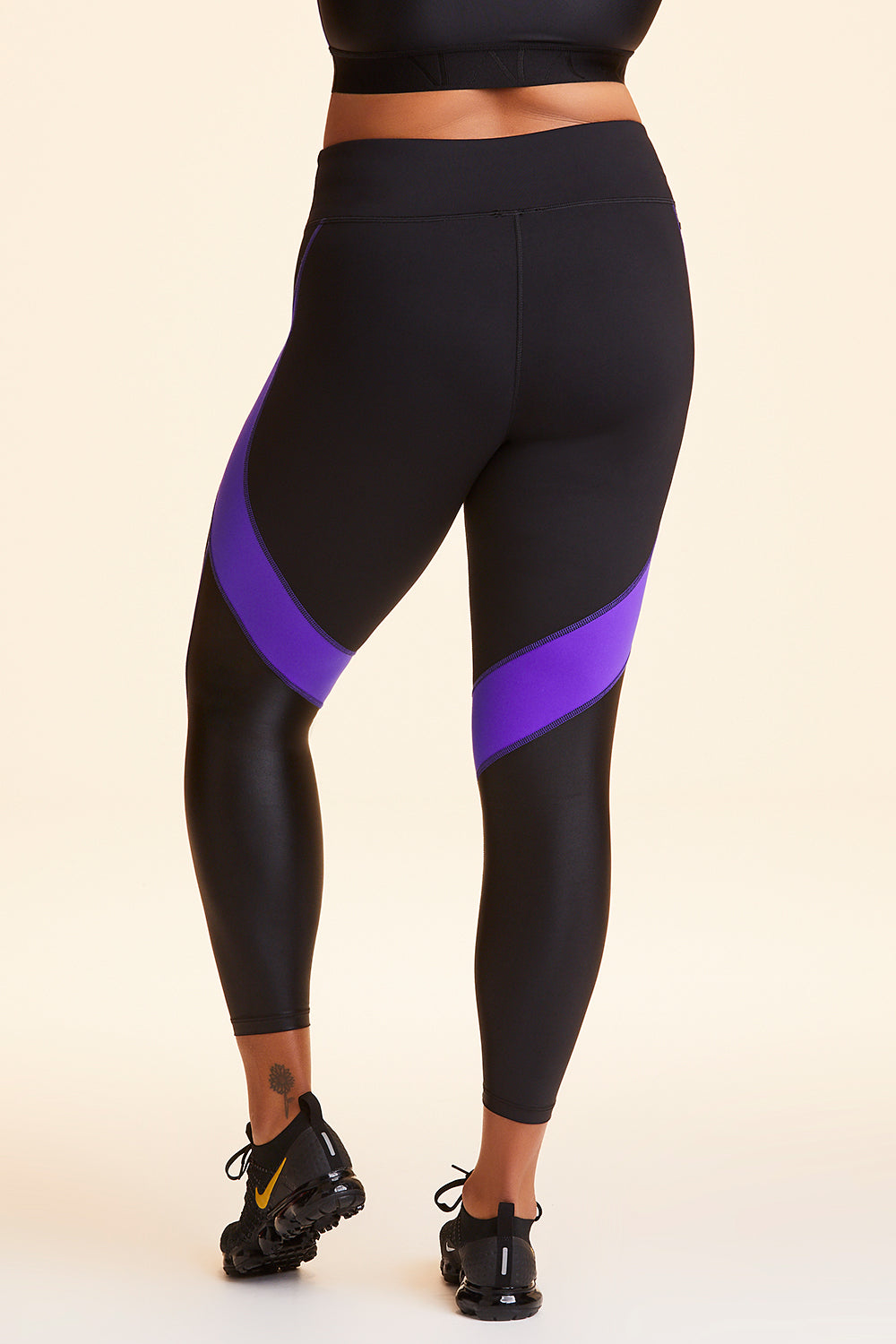 Back view of Alala Women's Luxury Athleisure black and purple color-blocked tight in plus size