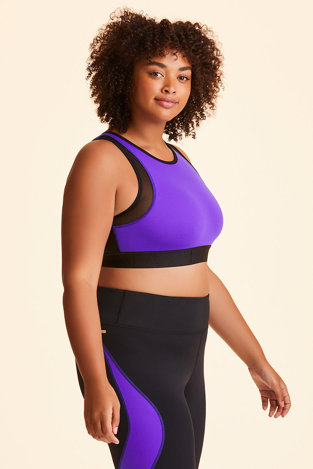 Side view of Alala Women's Luxury Athleisure black and purple color-blocked sports bra